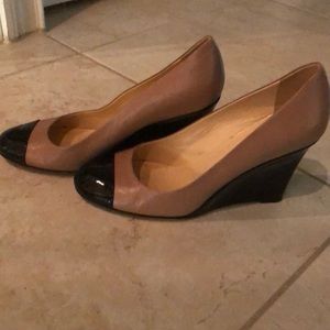 Kate Spade tan shoes with black heels.